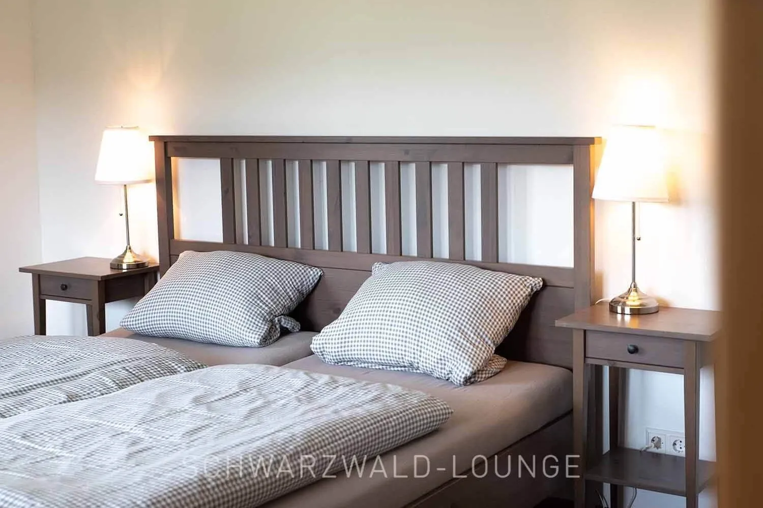 Schlafzimmer im Ferienhaus Brestenberg – gemütliches Doppelbett & warmes Ambiente Gemütliches Schlafzimmer im Ferienhaus Brestenberg mit Holzrahmenbett und warmem Licht.