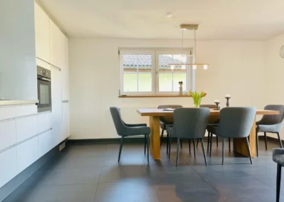 Moderner Essbereich mit großem Holztisch und gepolsterten Stühlen im Chalet Schwarzwald Lindenbuch.