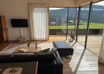 Wohnzimmer im Ferienhaus Baiersbronn Weitblick mit Panoramafenstern und Terrasse