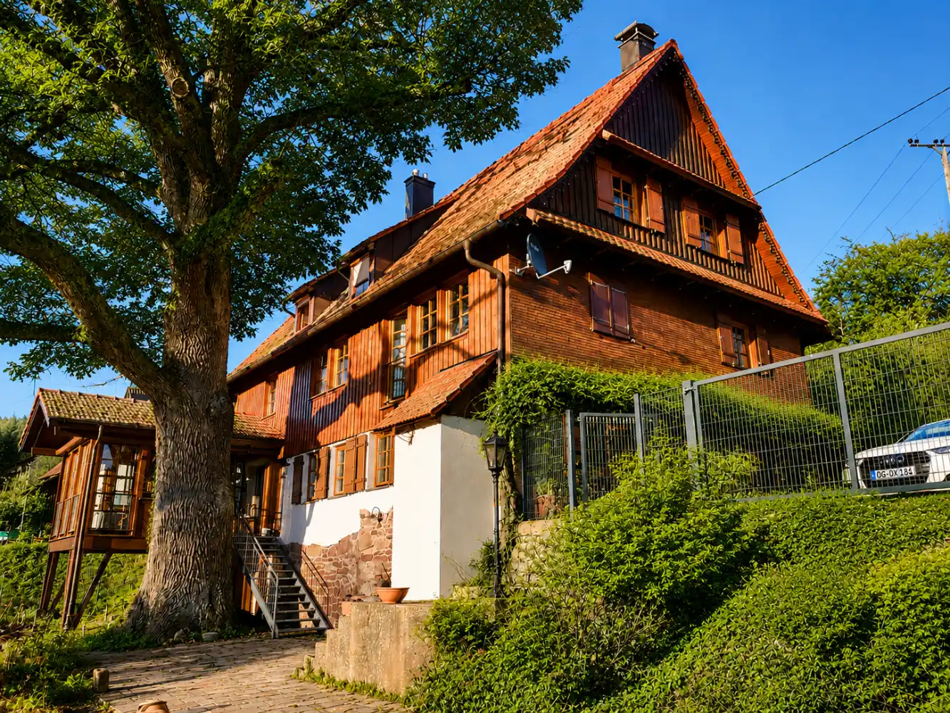 Außenansicht des Ferienhauses Refugium am Ursprung mit Holzfassade und Garten